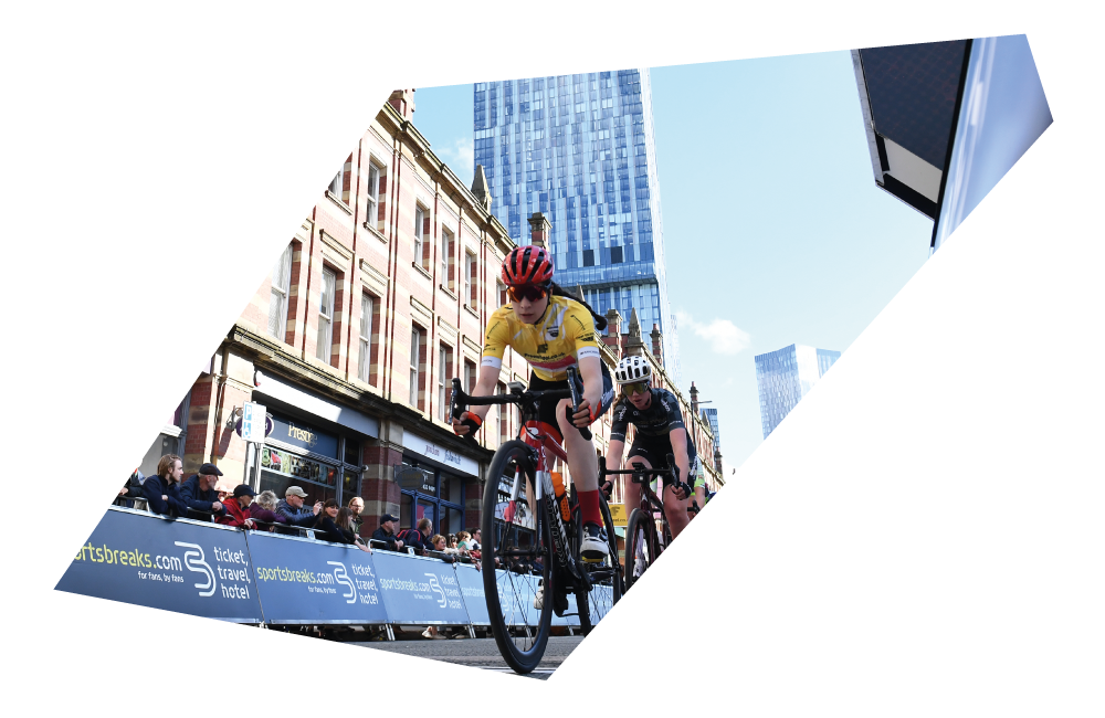 Two road cyclists racing with spectators lining the street