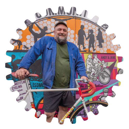 Person with bike against bright mural